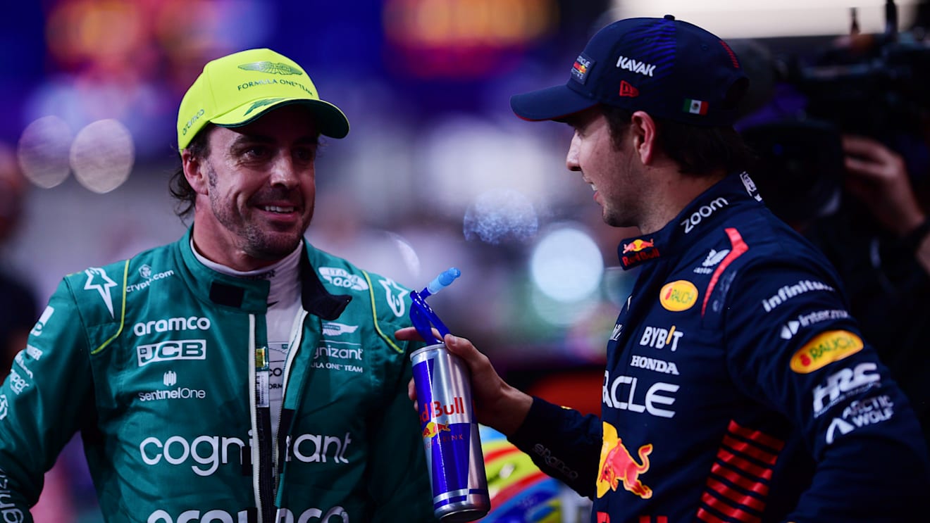 JEDDAH, SAUDI ARABIA - MARCH 18: Pole position qualifier Sergio Perez of Mexico and Oracle Red Bull Racing and and Third placed qualifier Fernando Alonso of Spain and Aston Martin F1 Team talk in parc ferme during qualifying ahead of the F1 Grand Prix of Saudi Arabia at Jeddah Corniche Circuit on March 18, 2023 in Jeddah, Saudi Arabia. (Photo by Mario Renzi - Formula 1/Formula 1 via Getty Images)