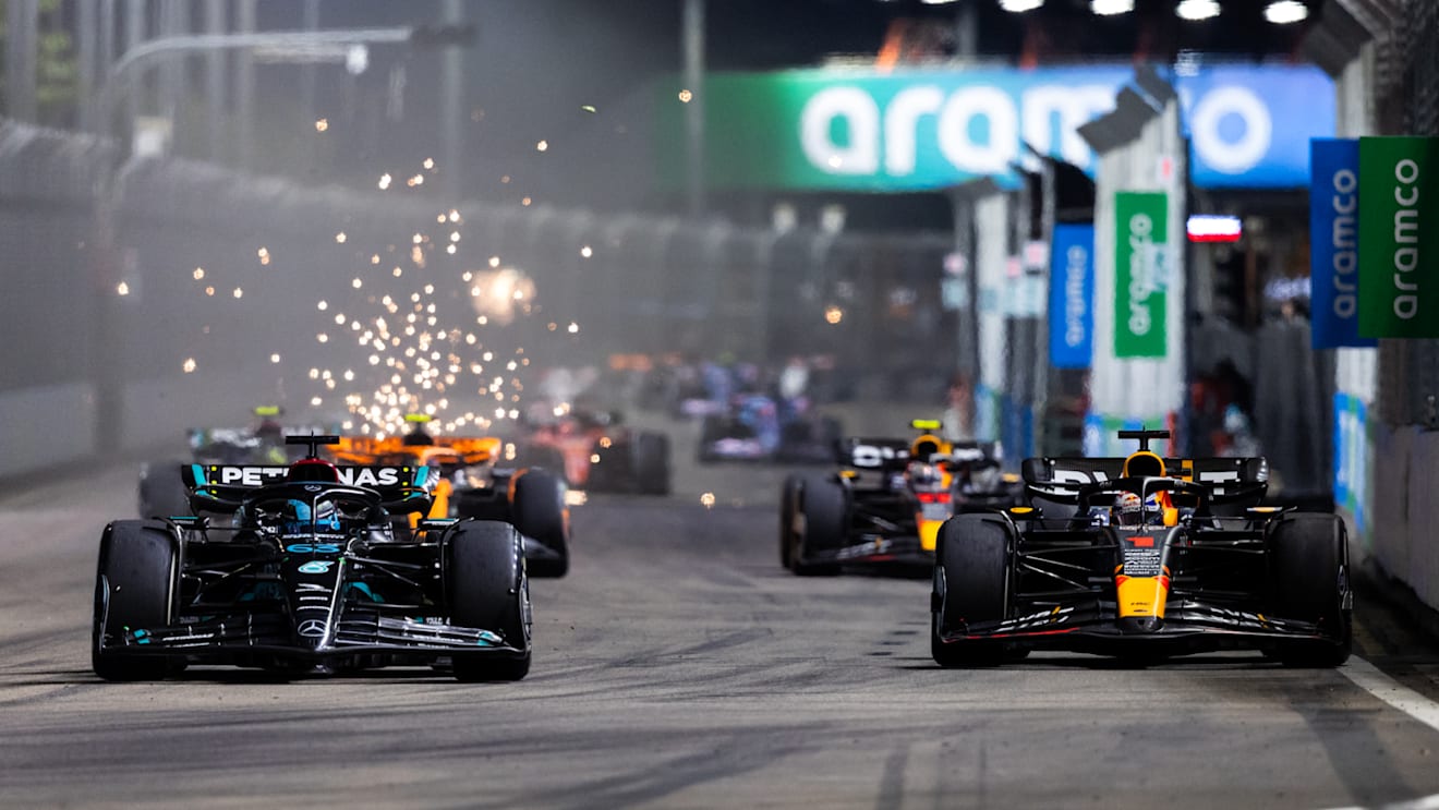 SINGAPORE, SINGAPORE - SEPTEMBER 17: George Russell of Great Britain driving the (63) Mercedes AMG Petronas F1 Team W14 and Max Verstappen of the Netherlands driving the (1) Oracle Red Bull Racing RB19 compete for position on track during the F1 Grand Prix of Singapore at Marina Bay Street Circuit on September 17, 2023 in Singapore, Singapore. (Photo by Clive Rose/Getty Images)