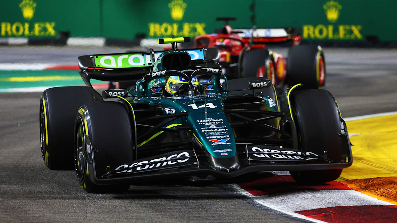 SINGAPORE, SINGAPORE - SEPTEMBER 22: Fernando Alonso of Spain driving the (14) Aston Martin AMR24 Mercedes leads Charles Leclerc of Monaco driving the (16) Ferrari SF-24 on track during the F1 Grand Prix of Singapore at Marina Bay Street Circuit on September 22, 2024 in Singapore, Singapore. (Photo by Clive Rose - Formula 1/Formula 1 via Getty Images)