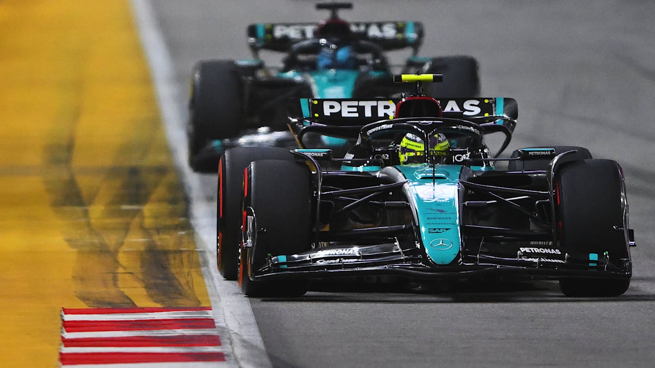 SINGAPORE, SINGAPORE - SEPTEMBER 22: Lewis Hamilton of Great Britain driving the (44) Mercedes AMG Petronas F1 Team W15 leads George Russell of Great Britain driving the (63) Mercedes AMG Petronas F1 Team W15 on track during the F1 Grand Prix of Singapore at Marina Bay Street Circuit on September 22, 2024 in Singapore, Singapore. (Photo by Rudy Carezzevoli/Getty Images)