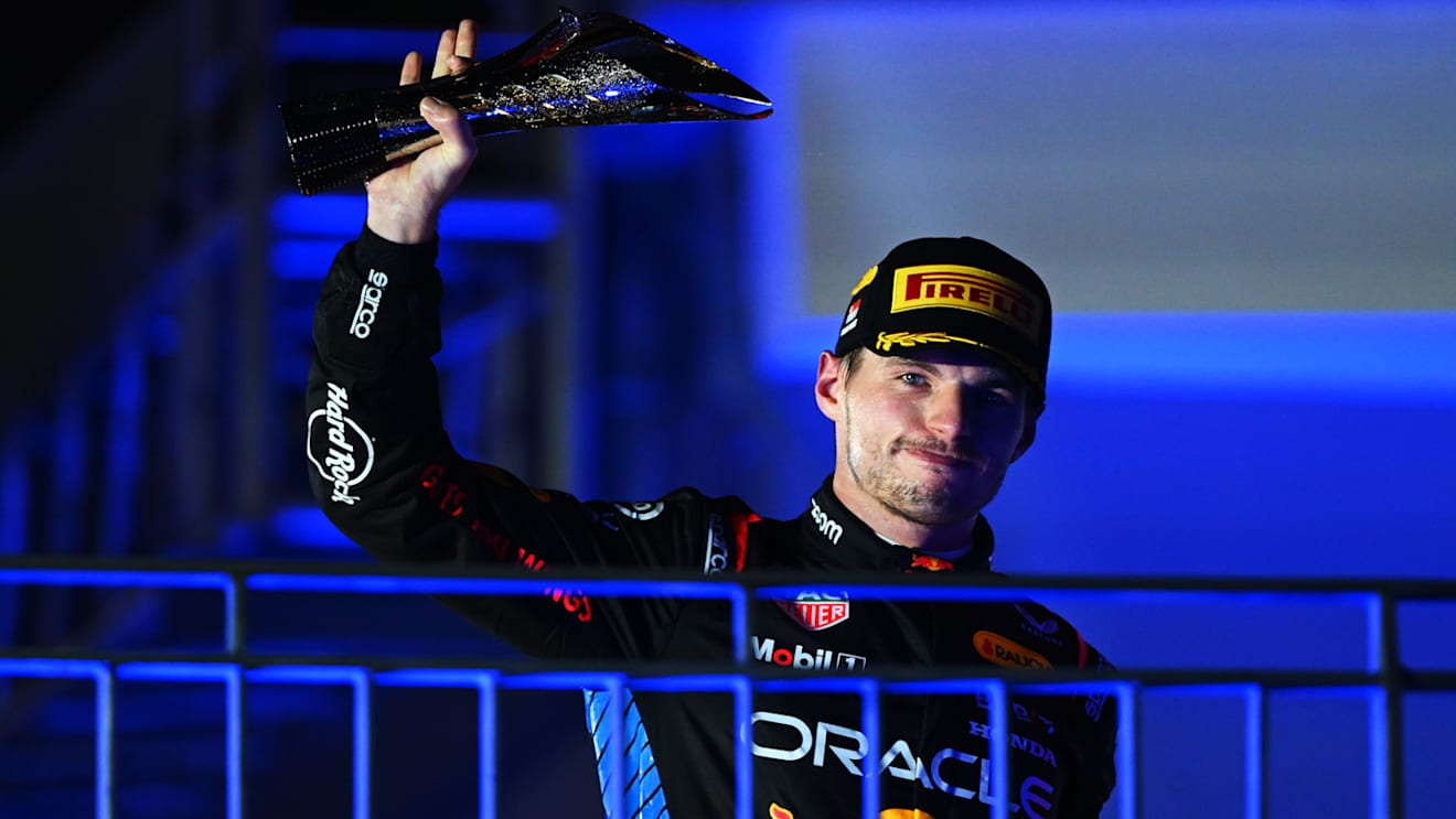 SINGAPORE, SINGAPORE - SEPTEMBER 22: Second placed Max Verstappen of the Netherlands and Oracle Red Bull Racing celebrates on the podium during the F1 Grand Prix of Singapore at Marina Bay Street Circuit on September 22, 2024 in Singapore, Singapore. (Photo by Clive Mason/Getty Images)