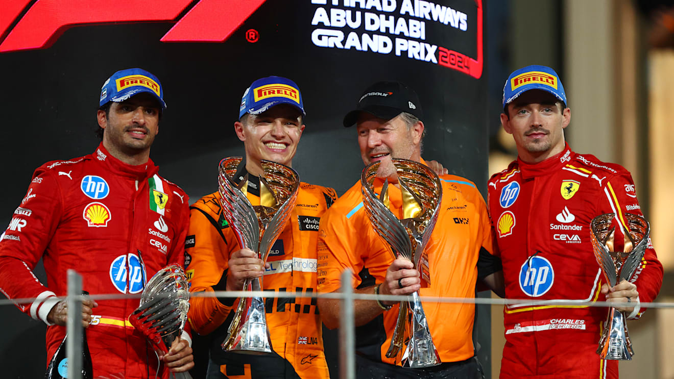 ABU DHABI, UNITED ARAB EMIRATES - DECEMBER 08: Race winner Lando Norris of Great Britain and McLaren, Second placed Carlos Sainz of Spain and Ferrari, Third placed Charles Leclerc of Monaco and Ferrari and McLaren Chief Executive Officer Zak Brown celebrate on the podium during the F1 Grand Prix of Abu Dhabi at Yas Marina Circuit on December 08, 2024 in Abu Dhabi, United Arab Emirates. (Photo by Joe Portlock/Getty Images)