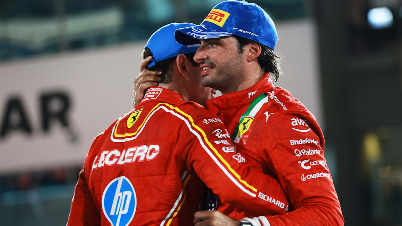 ABU DHABI, UNITED ARAB EMIRATES - DECEMBER 08: Second placed Carlos Sainz of Spain and Ferrari and Third placed Charles Leclerc of Monaco and Ferrari celebrate on the podium during the F1 Grand Prix of Abu Dhabi at Yas Marina Circuit on December 08, 2024 in Abu Dhabi, United Arab Emirates. (Photo by Bryn Lennon - Formula 1/Formula 1 via Getty Images)