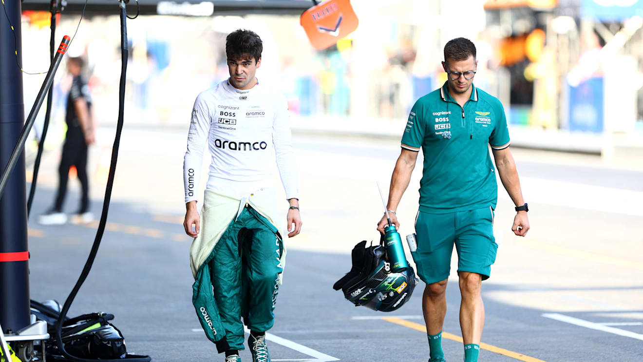 BAKU, AZERBAIJAN - SEPTEMBER 14: 15th placed qualifier Lance Stroll of Canada and Aston Martin F1 Team walks in the Pitlane during qualifying ahead of the F1 Grand Prix of Azerbaijan at Baku City Circuit on September 14, 2024 in Baku, Azerbaijan. (Photo by Clive Rose - Formula 1/Formula 1 via Getty Images)