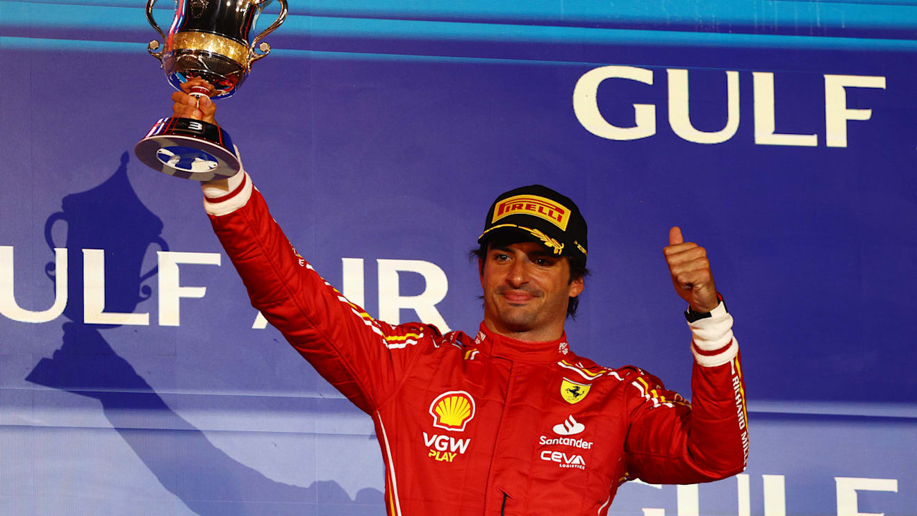 BAHRAIN, BAHRAIN - MARCH 02: Third placed Carlos Sainz of Spain and Ferrari celebrates on the podium during the F1 Grand Prix of Bahrain at Bahrain International Circuit on March 02, 2024 in Bahrain, Bahrain. (Photo by Clive Rose/Getty Images)