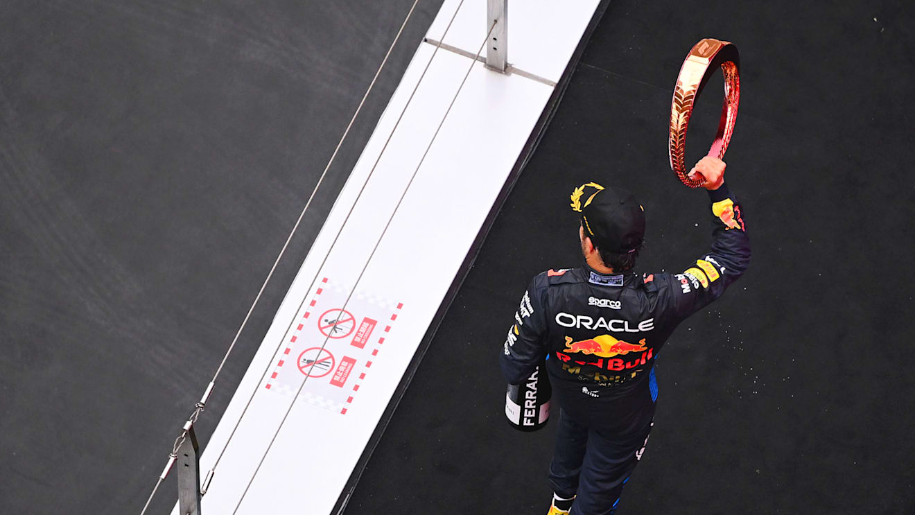 SHANGHAI, CHINA - APRIL 21: Third placed Sergio Perez of Mexico and Oracle Red Bull Racing celebrates on the podium during the F1 Grand Prix of China at Shanghai International Circuit on April 21, 2024 in Shanghai, China. (Photo by Clive Mason - Formula 1/Formula 1 via Getty Images)