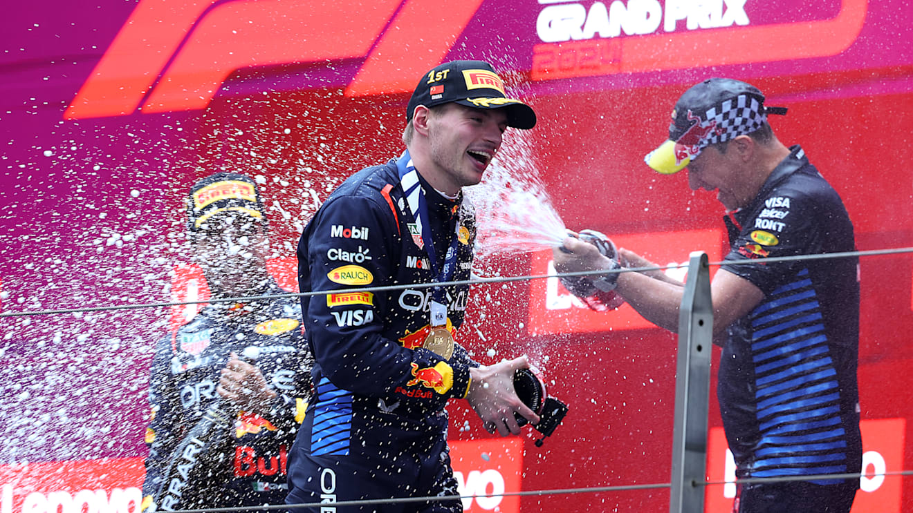 SHANGHAI, CHINA - APRIL 21: Race winner Max Verstappen of the Netherlands and Oracle Red Bull Racing, Third placed Sergio Perez of Mexico and Oracle Red Bull Racing and Oracle Red Bull Racing Head of Car Engineering Paul Monaghan celebrate on the podium during the F1 Grand Prix of China at Shanghai International Circuit on April 21, 2024 in Shanghai, China. (Photo by Lintao Zhang/Getty Images )