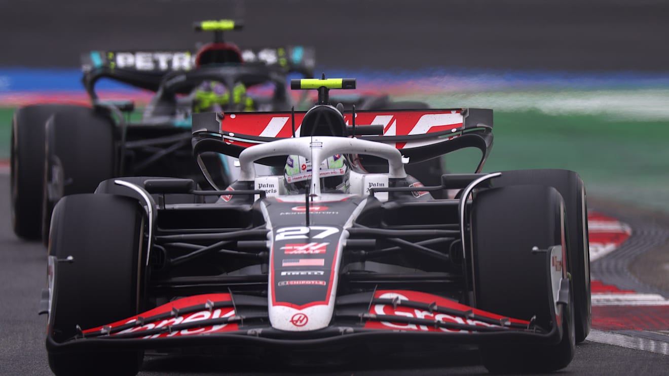 SHANGHAI, CHINA - APRIL 21: Nico Hulkenberg of Germany driving the (27) Haas F1 VF-24 Ferrari leads Lewis Hamilton of Great Britain driving the (44) Mercedes AMG Petronas F1 Team W15 on track during the F1 Grand Prix of China at Shanghai International Circuit on April 21, 2024 in Shanghai, China. (Photo by Lars Baron/Getty Images)