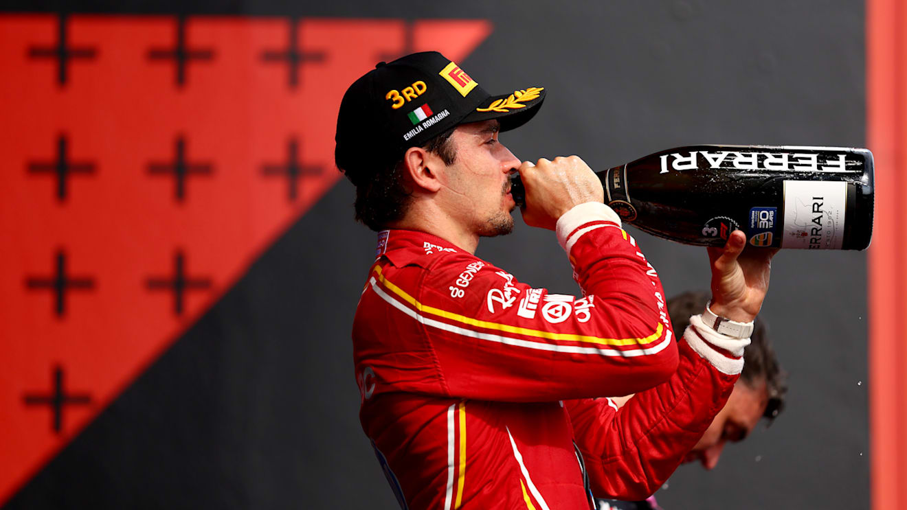 IMOLA, ITALY - MAY 19: Third placed Charles Leclerc of Monaco and Ferrari celebrates on the podium during the F1 Grand Prix of Emilia-Romagna at Autodromo Enzo e Dino Ferrari Circuit on May 19, 2024 in Imola, Italy. (Photo by Bryn Lennon - Formula 1/Formula 1 via Getty Images)