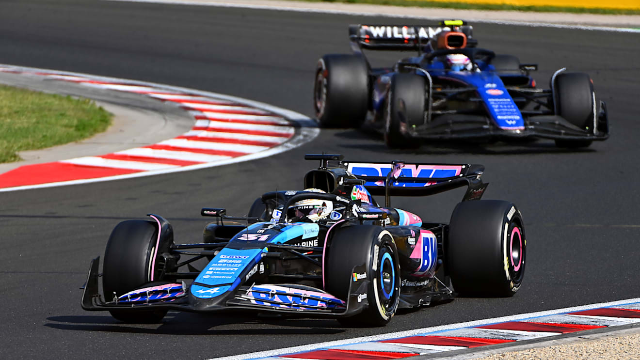 BUDAPEST, HUNGARY - JULY 21: Esteban Ocon of France driving the (31) Alpine F1 A524 Renault leads Logan Sargeant of United States driving the (2) Williams FW46 Mercedes on track  during the F1 Grand Prix of Hungary at Hungaroring on July 21, 2024 in Budapest, Hungary. (Photo by James Sutton - Formula 1/Formula 1 via Getty Images)