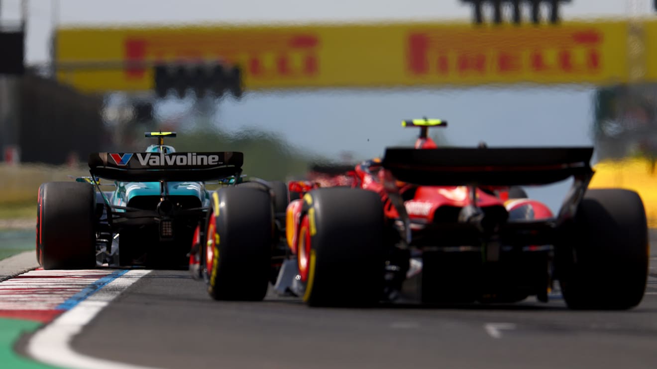 BUDAPEST, HUNGARY - JULY 21: Fernando Alonso of Spain driving the (14) Aston Martin AMR24 Mercedes leads Carlos Sainz of Spain driving (55) the Ferrari SF-24 on track during the F1 Grand Prix of Hungary at Hungaroring on July 21, 2024 in Budapest, Hungary. (Photo by Bryn Lennon - Formula 1/Formula 1 via Getty Images)