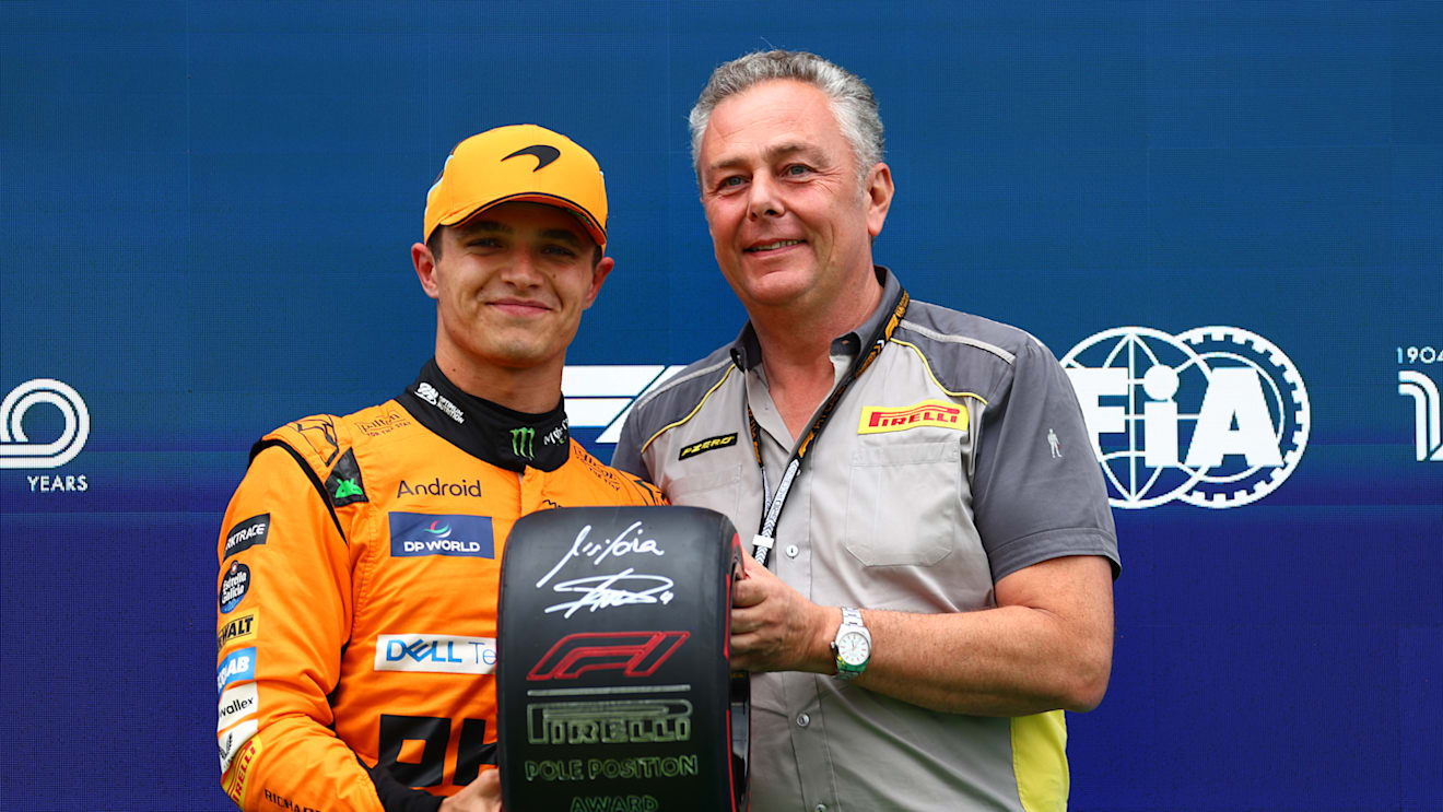 BUDAPEST, HUNGARY - JULY 20: Pole position qualifier Lando Norris of Great Britain and McLaren is presented with the Pirelli Pole Position trophy by Director of Pirelli F1 Mario Isola in parc ferme during qualifying ahead of the F1 Grand Prix of Hungary at Hungaroring on July 20, 2024 in Budapest, Hungary. (Photo by Bryn Lennon - Formula 1/Formula 1 via Getty Images)
