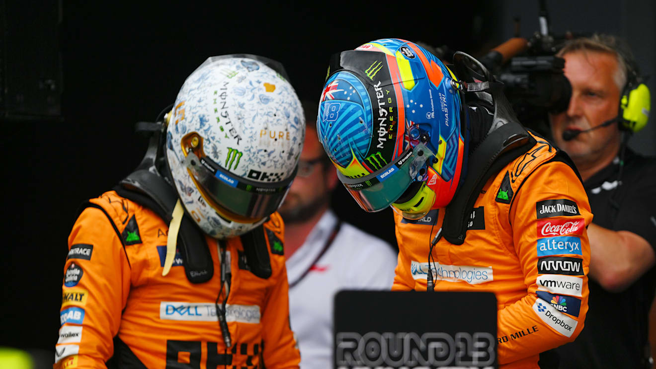 BUDAPEST, HUNGARY - JULY 20: Pole position qualifier Lando Norris of Great Britain and McLaren and Second placed qualifier Oscar Piastri of Australia and McLaren talk in parc ferme during qualifying ahead of the F1 Grand Prix of Hungary at Hungaroring on July 20, 2024 in Budapest, Hungary. (Photo by Rudy Carezzevoli/Getty Images)