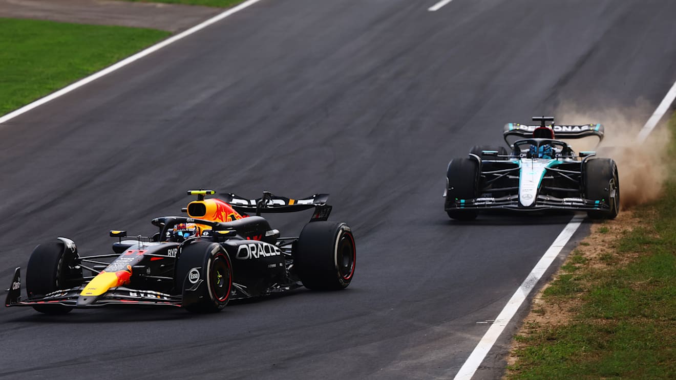 MONZA, ITALY - SEPTEMBER 01: Sergio Perez of Mexico driving the (11) Oracle Red Bull Racing RB20 leads George Russell of Great Britain driving the (63) Mercedes AMG Petronas F1 Team W15 on track during the F1 Grand Prix of Italy at Autodromo Nazionale Monza on September 01, 2024 in Monza, Italy. (Photo by Joe Portlock - Formula 1/Formula 1 via Getty Images)