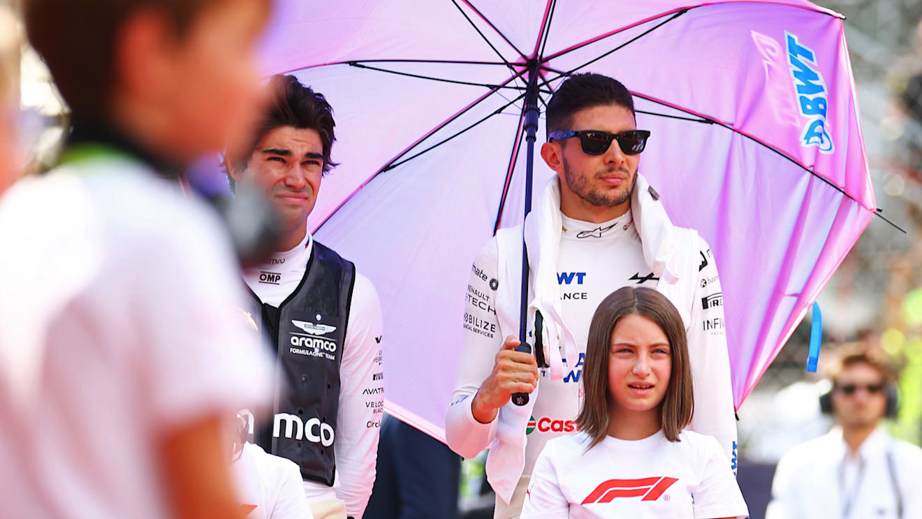 MONZA, ITALY - SEPTEMBER 01: Lance Stroll of Canada and Aston Martin F1 Team and Esteban Ocon of France and Alpine F1 looks on, on the grid during the F1 Grand Prix of Italy at Autodromo Nazionale Monza on September 01, 2024 in Monza, Italy. (Photo by Bryn Lennon - Formula 1/Formula 1 via Getty Images)