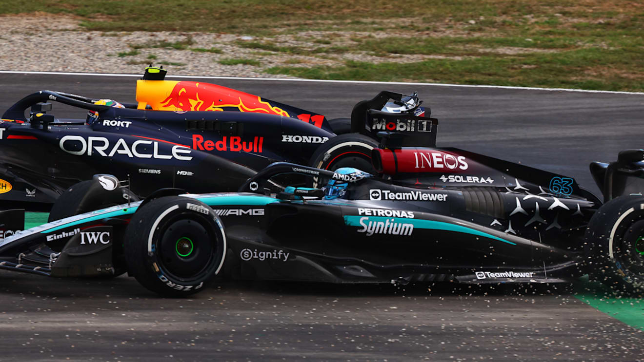 MONZA, ITALY - SEPTEMBER 01: George Russell of Great Britain driving the (63) Mercedes AMG Petronas F1 Team W15 runs wide during a battle with Sergio Perez of Mexico driving the (11) Oracle Red Bull Racing RB20 during the F1 Grand Prix of Italy at Autodromo Nazionale Monza on September 01, 2024 in Monza, Italy. (Photo by Joe Portlock - Formula 1/Formula 1 via Getty Images)