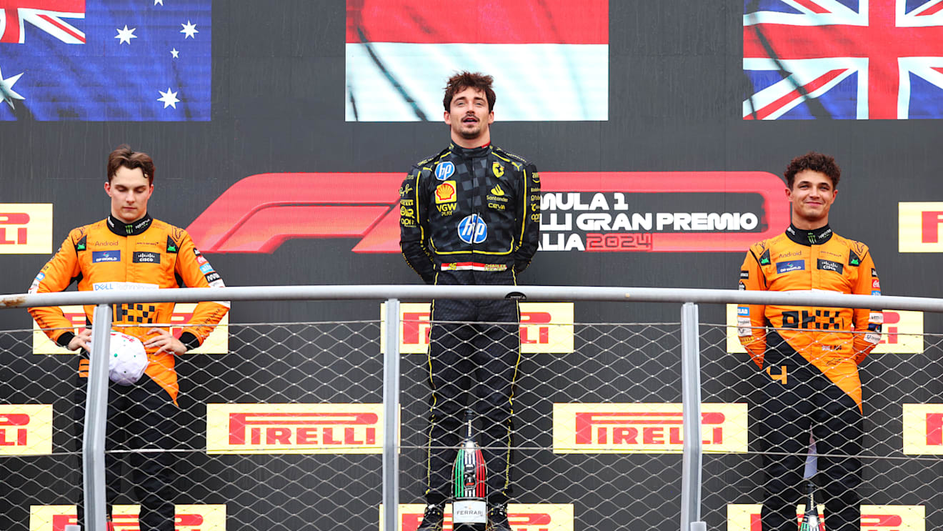MONZA, ITALY - SEPTEMBER 01: Race winner Charles Leclerc of Monaco and Ferrari, with Second placed Oscar Piastri of Australia and McLaren and Third placed Lando Norris of Great Britain and McLaren, on the podium during the F1 Grand Prix of Italy at Autodromo Nazionale Monza on September 01, 2024 in Monza, Italy. (Photo by Clive Rose/Getty Images)