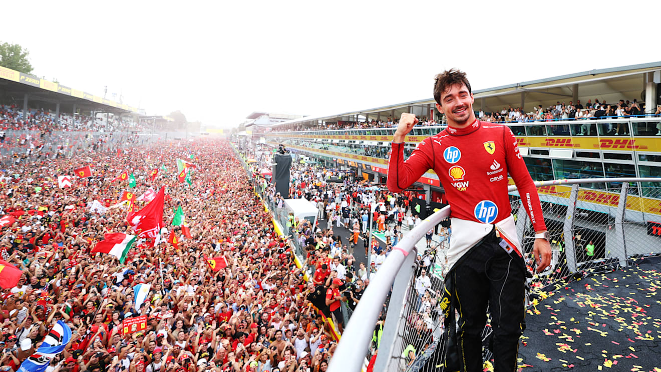 MONZA, ITALY - SEPTEMBER 01: Race winner Charles Leclerc of Monaco and Ferrari poses for a picture on the podium, with the fans down on the track during the F1 Grand Prix of Italy at Autodromo Nazionale Monza on September 01, 2024 in Monza, Italy. (Photo by Bryn Lennon - Formula 1/Formula 1 via Getty Images)