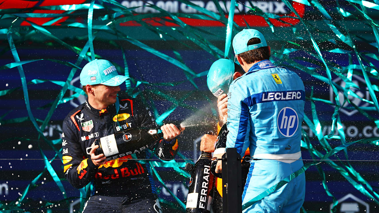 MIAMI, FLORIDA - MAY 05: Second placed Max Verstappen of the Netherlands and Oracle Red Bull Racing and Third placed Charles Leclerc of Monaco and Ferrari celebrate with Race winner Lando Norris of Great Britain and McLaren on the podium during the F1 Grand Prix of Miami at Miami International Autodrome on May 05, 2024 in Miami, Florida. (Photo by Mark Thompson/Getty Images)