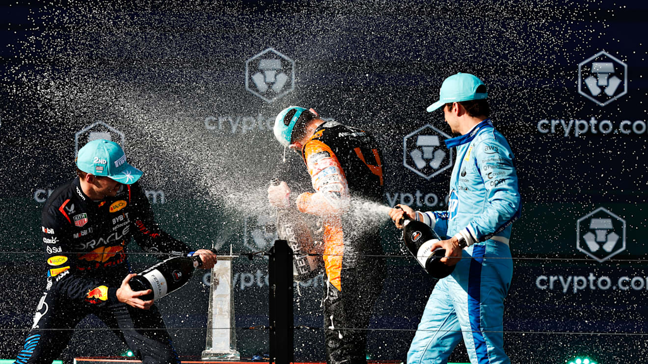MIAMI, FLORIDA - MAY 05: Race winner Lando Norris of Great Britain and McLaren, Second placed Max Verstappen of the Netherlands and Oracle Red Bull Racing and Third placed Charles Leclerc of Monaco and Ferrari celebrate on the podium after the F1 Grand Prix of Miami at Miami International Autodrome on May 05, 2024 in Miami, Florida. (Photo by Chris Graythen/Getty Images)