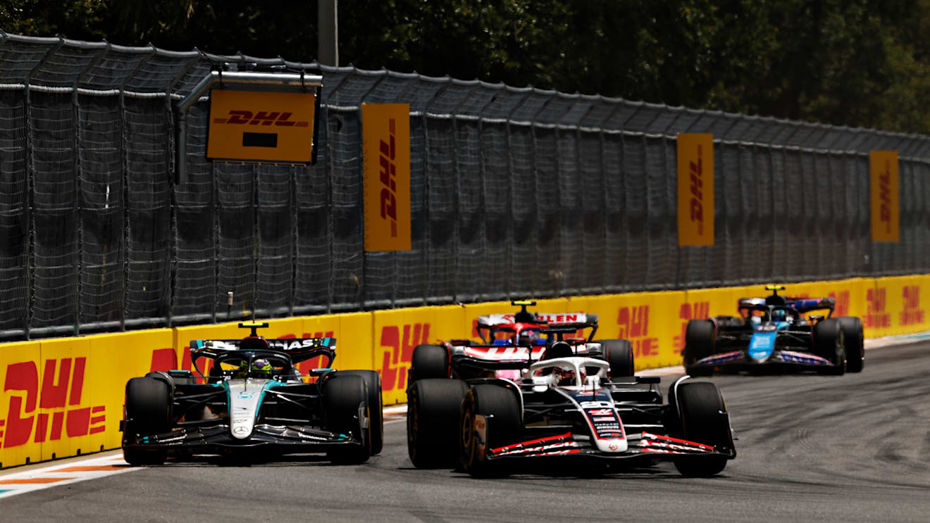 MIAMI, FLORIDA - MAY 04: Kevin Magnussen of Denmark driving the (20) Haas F1 VF-24 Ferrari leads Lewis Hamilton of Great Britain driving the (44) Mercedes AMG Petronas F1 Team W15 during the Sprint ahead of the F1 Grand Prix of Miami at Miami International Autodrome on May 04, 2024 in Miami, Florida. (Photo by Chris Graythen/Getty Images)