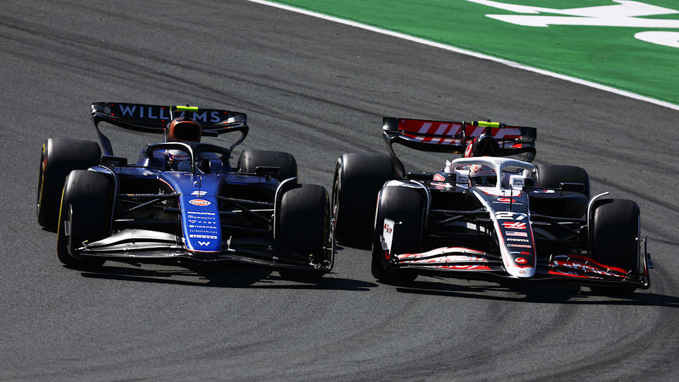 ZANDVOORT, NETHERLANDS - AUGUST 25: Nico Hulkenberg of Germany driving the (27) Haas F1 VF-24 Ferrari and Logan Sargeant of United States driving the (2) Williams FW46 Mercedes battle for track position during the F1 Grand Prix of Netherlands at Circuit Zandvoort on August 25, 2024 in Zandvoort, Netherlands. (Photo by Mark Thompson/Getty Images)