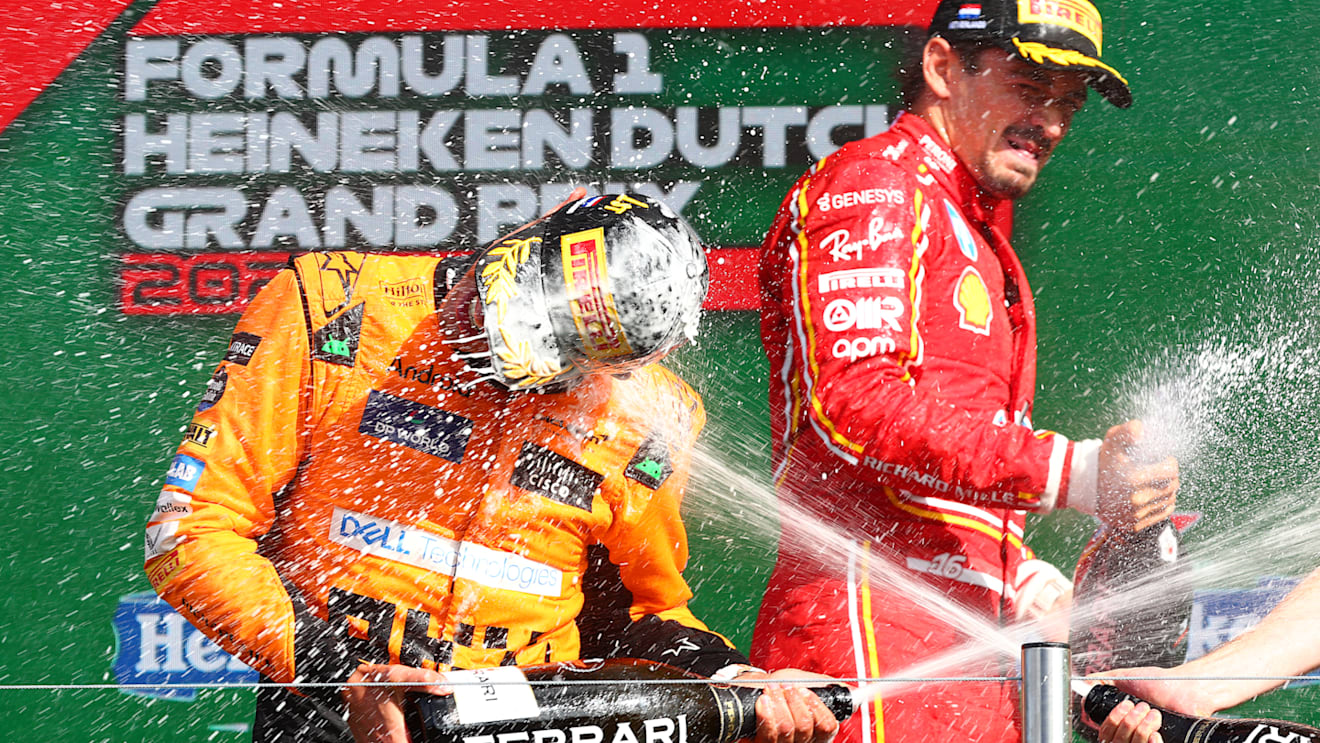 ZANDVOORT, NETHERLANDS - AUGUST 25: Race winner Lando Norris of Great Britain and McLaren and third placed Charles Leclerc of Monaco and Ferrari celebrate in parc ferme after the F1 Grand Prix of Netherlands at Circuit Zandvoort on August 25, 2024 in Zandvoort, Netherlands. (Photo by Joe Portlock/Getty Images)