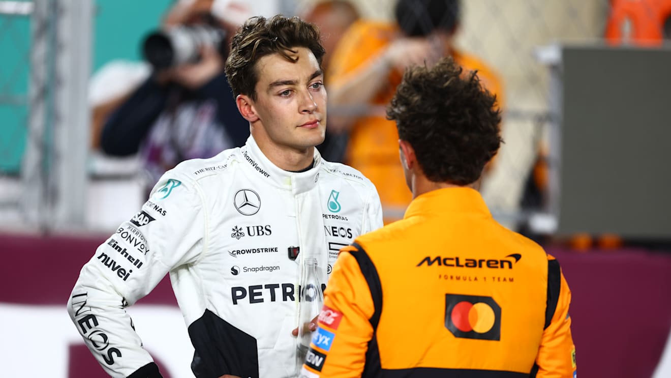 LUSAIL CITY, QATAR - NOVEMBER 30: Second placed Lando Norris of Great Britain and McLaren and Third placed George Russell of Great Britain and Mercedes talk in parc ferme during the Sprint ahead of the F1 Grand Prix of Qatar at Lusail International Circuit on November 30, 2024 in Lusail City, Qatar. (Photo by Mark Thompson/Getty Images)