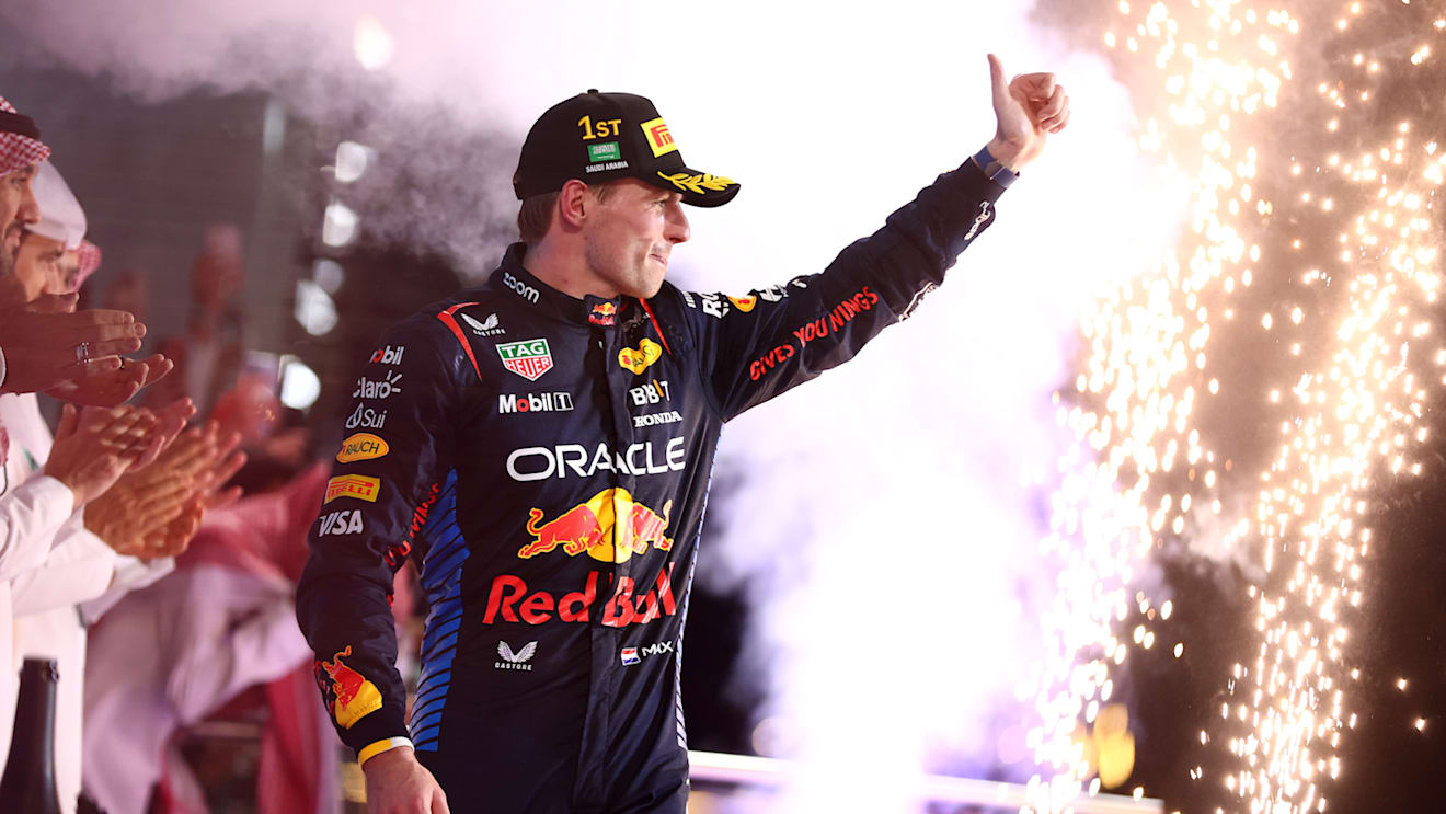 JEDDAH, SAUDI ARABIA - MARCH 09: Race winner Max Verstappen of the Netherlands and Oracle Red Bull Racing celebrates on the podium during the F1 Grand Prix of Saudi Arabia at Jeddah Corniche Circuit on March 09, 2024 in Jeddah, Saudi Arabia. (Photo by Bryn Lennon - Formula 1/Formula 1 via Getty Images)