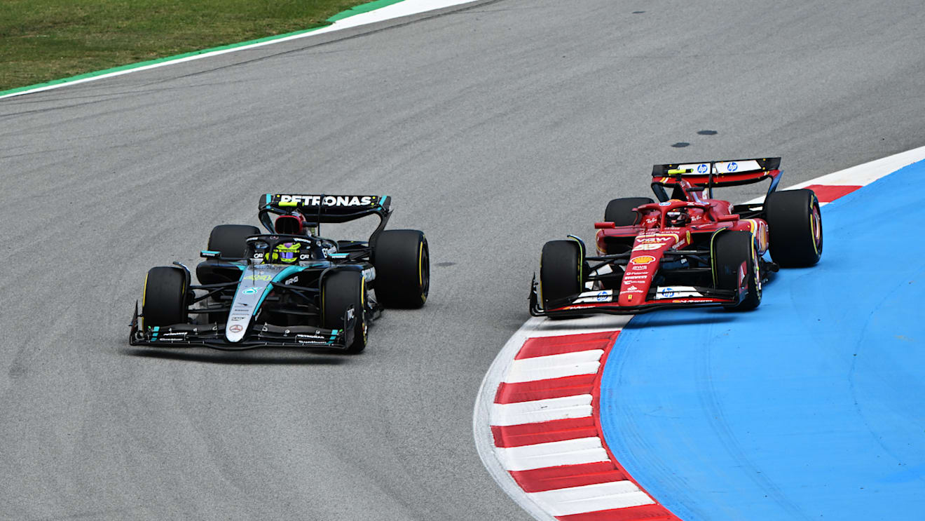 BARCELONA, SPAIN - JUNE 23: Lewis Hamilton of Great Britain driving the (44) Mercedes AMG Petronas F1 Team W15 and Carlos Sainz of Spain driving (55) the Ferrari SF-24 battle for track position during the F1 Grand Prix of Spain at Circuit de Barcelona-Catalunya on June 23, 2024 in Barcelona, Spain. (Photo by Mark Sutton - Formula 1/Formula 1 via Getty Images)