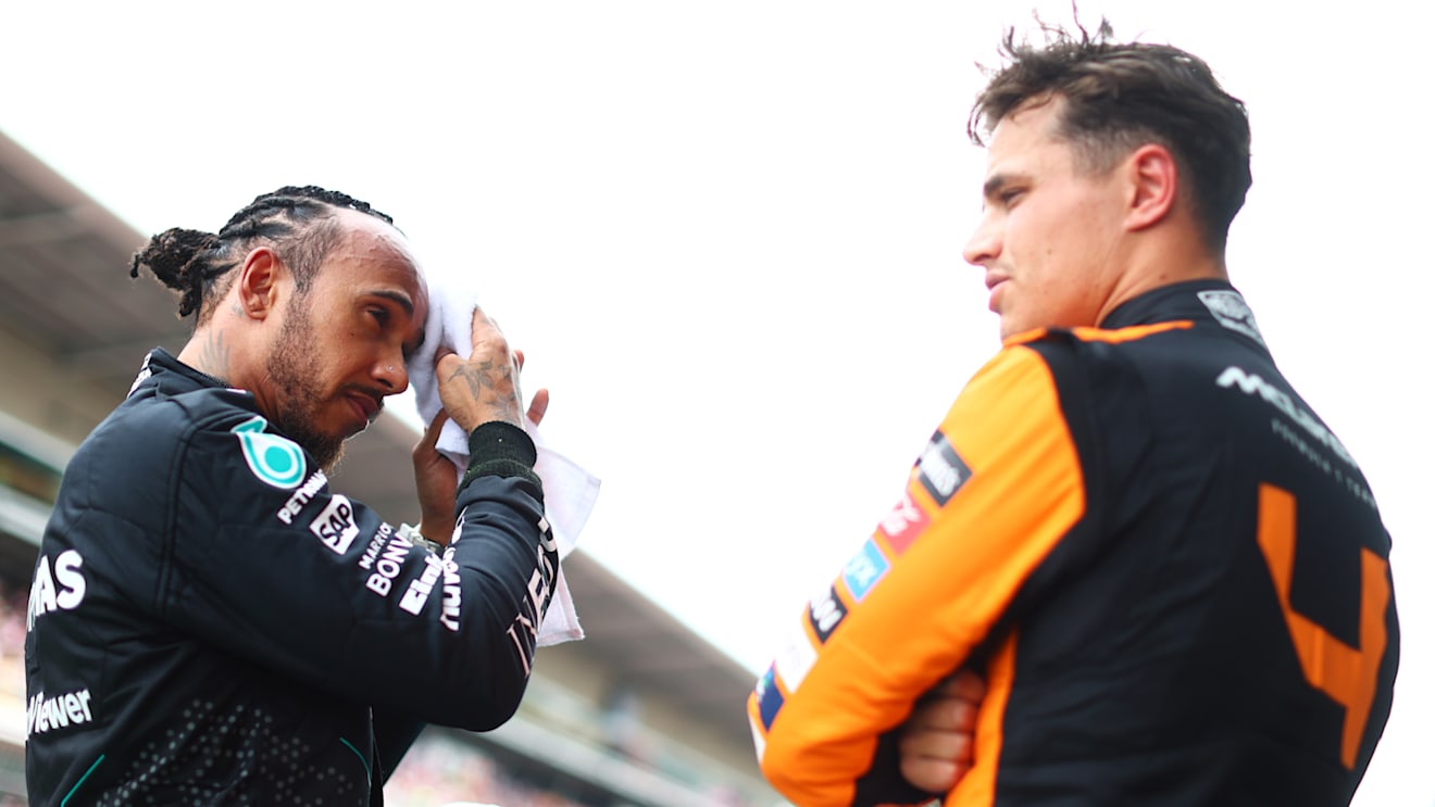 BARCELONA, SPAIN - JUNE 22: Pole position qualifier Lando Norris of Great Britain and McLaren and Third placed qualifier Lewis Hamilton of Great Britain and Mercedes talk in parc ferme during qualifying ahead of the F1 Grand Prix of Spain at Circuit de Barcelona-Catalunya on June 22, 2024 in Barcelona, Spain. (Photo by Clive Rose - Formula 1/Formula 1 via Getty Images)
