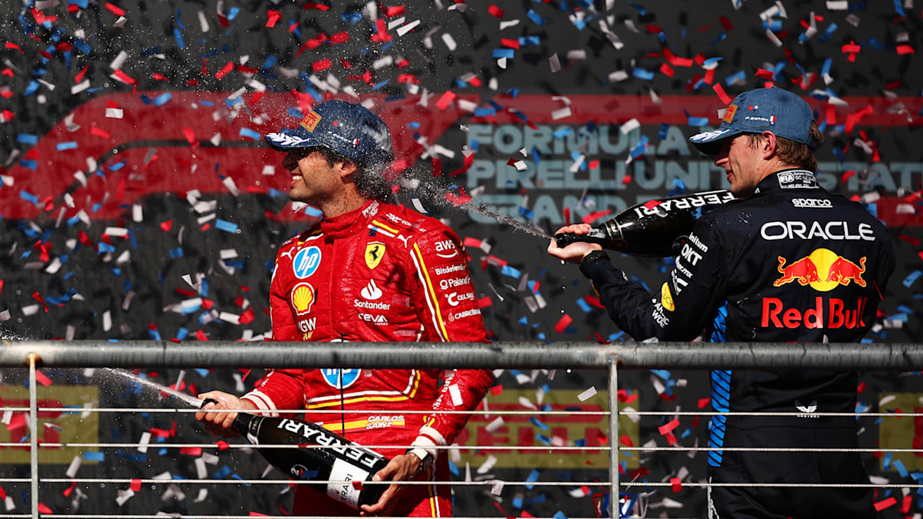 AUSTIN, TEXAS - OCTOBER 20: Second placed Carlos Sainz of Spain and Ferrari and Third placed Max Verstappen of the Netherlands and Oracle Red Bull Racing celebrate on the podium after the F1 Grand Prix of United States at Circuit of The Americas on October 20, 2024 in Austin, Texas. (Photo by Jared C. Tilton/Getty Images)