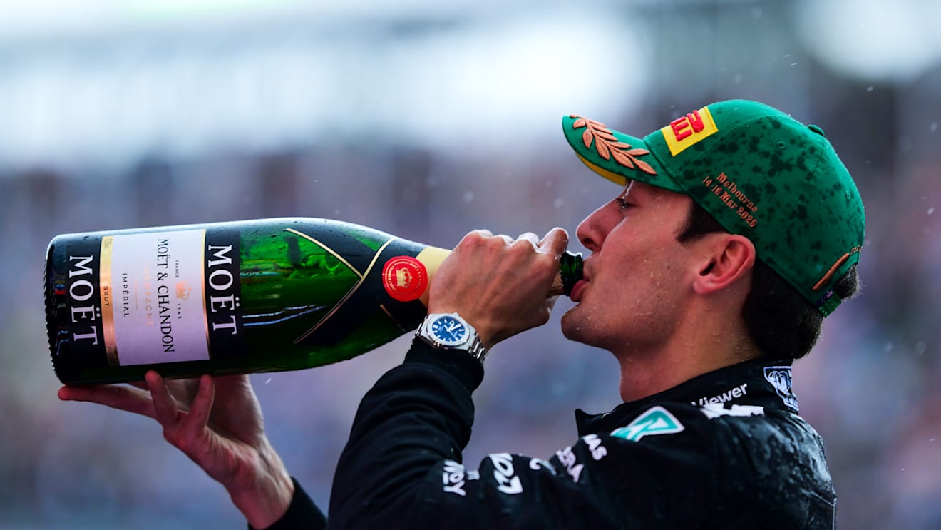 MELBOURNE, AUSTRALIA - MARCH 16: Third placed George Russell of Great Britain and Mercedes AMG Petronas F1 Team celebrates with Champagne on the podium  during the F1 Grand Prix of Australia at Albert Park Grand Prix Circuit on March 16, 2025 in Melbourne, Australia. (Photo by Mario Renzi - Formula 1/Formula 1 via Getty Images)
