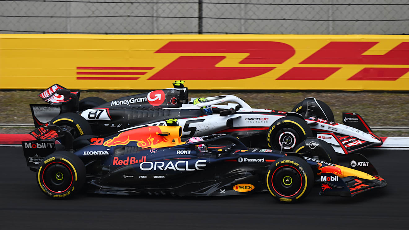 SHANGHAI, CHINA - MARCH 23: Liam Lawson of New Zealand driving the (30) Oracle Red Bull Racing RB21 and Oliver Bearman of Great Britain driving the (87) Haas F1 VF-25 Ferrari battle for track position during the F1 Grand Prix of China at Shanghai International Circuit on March 23, 2025 in Shanghai, China. (Photo by Clive Mason/Getty Images)