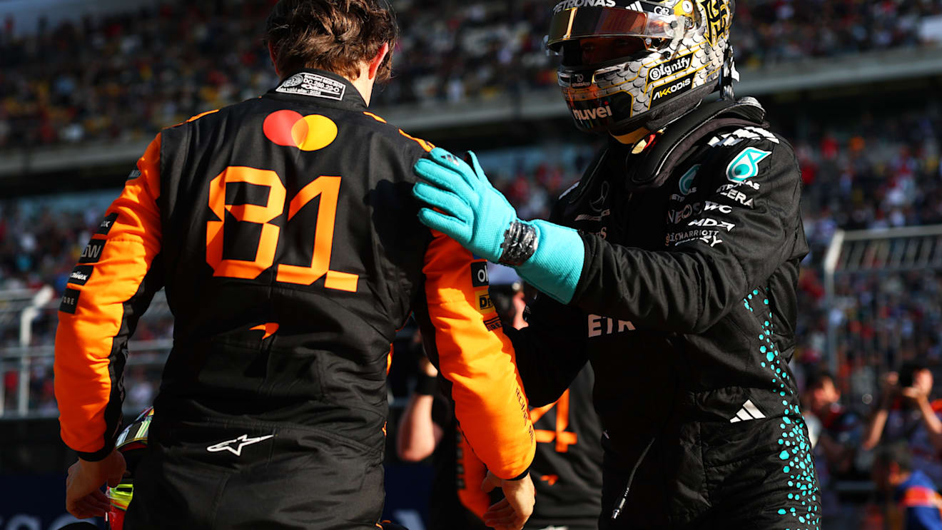 SHANGHAI, CHINA - MARCH 22: Pole position qualifier Oscar Piastri of Australia and McLaren is congratulated by Second placed qualifier George Russell of Great Britain and Mercedes AMG Petronas F1 Team in parc ferme during qualifying ahead of the F1 Grand Prix of China at Shanghai International Circuit on March 22, 2025 in Shanghai, China. (Photo by Bryn Lennon - Formula 1/Formula 1 via Getty Images)