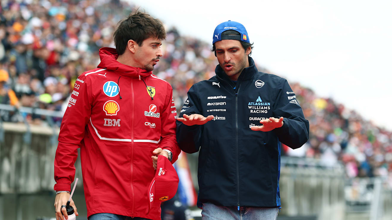 SUZUKA, JAPAN - APRIL 06: Charles Leclerc of Monaco and Scuderia Ferrari and Carlos Sainz of Spain and Williams talk on the drivers parade prior to the F1 Grand Prix of Japan at Suzuka Circuit on April 06, 2025 in Suzuka, Japan. (Photo by Clive Rose/Getty Images)