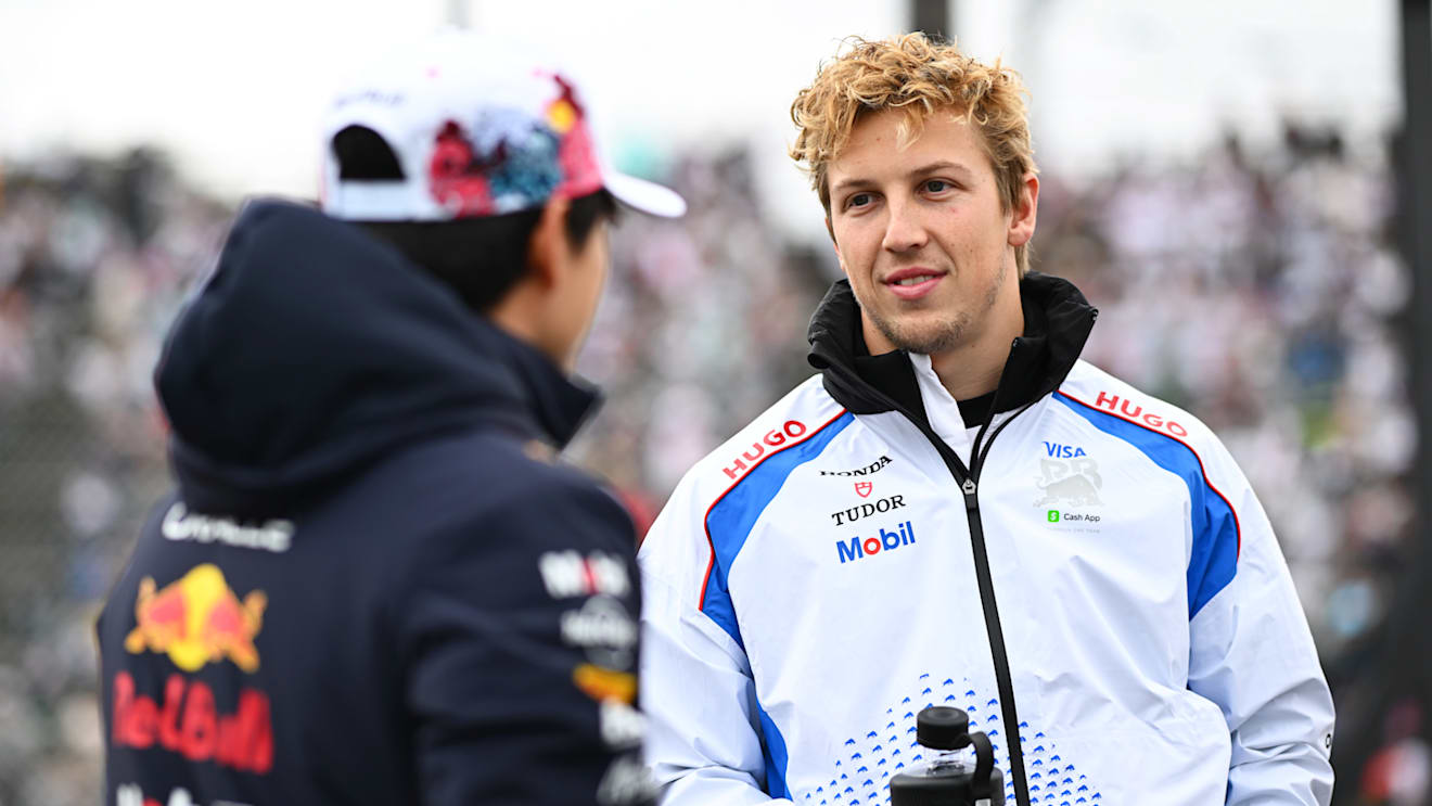SUZUKA, JAPAN - APRIL 06: Yuki Tsunoda of Japan and Oracle Red Bull Racing and Liam Lawson of New Zealand and Visa Cash App Racing Bulls talk on the drivers parade prior to the F1 Grand Prix of Japan at Suzuka Circuit on April 06, 2025 in Suzuka, Japan. (Photo by Rudy Carezzevoli/Getty Images)