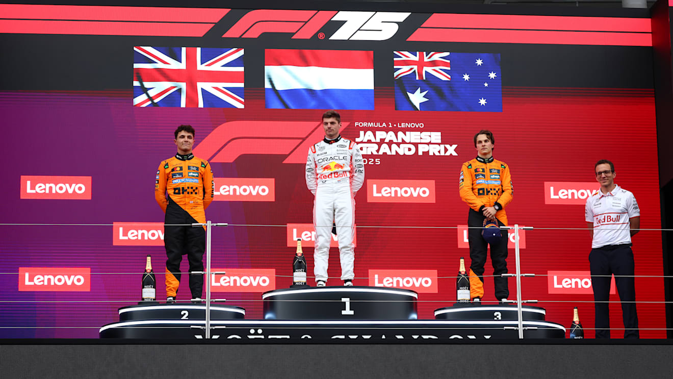 SUZUKA, JAPAN - APRIL 06: Second placed Lando Norris of Great Britain and McLaren Race winner Max Verstappen of the Netherlands and Oracle Red Bull Racing Third placed Oscar Piastri of Australia and McLaren and Hugh Bird, Race Engineer of Oracle Red Bull Racing on the podium during the F1 Grand Prix of Japan at Suzuka Circuit on April 06, 2025 in Suzuka, Japan. (Photo by Clive Rose/Getty Images)