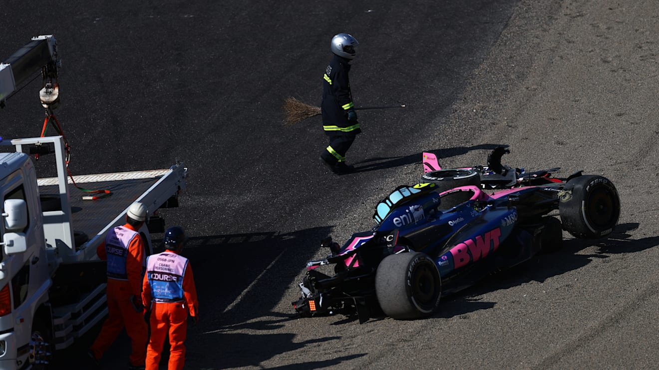 SUZUKA, JAPAN - APRIL 04: Marshals remove the damaged car of Jack Doohan of Australia driving the (7) Alpine F1 A525 Renault from the circuit after a crash during practice ahead of the F1 Grand Prix of Japan at Suzuka Circuit on April 04, 2025 in Suzuka, Japan. (Photo by Bryn Lennon - Formula 1/Formula 1 via Getty Images)