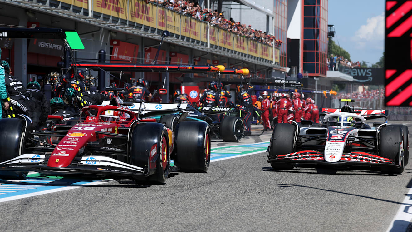 IMOLA, ITALY - MAY 18: Charles Leclerc of Monaco driving the (16) Scuderia Ferrari SF-25 and Oliver Bearman of Great Britain driving the (87) Haas F1 VF-25 Ferrari in the pitlane during the F1 Grand Prix of Emilia-Romagna at Autodromo Internazionale Enzo e Dino Ferrari on May 18, 2025 in Imola, Italy. (Photo by Mark Thompson/Getty Images)