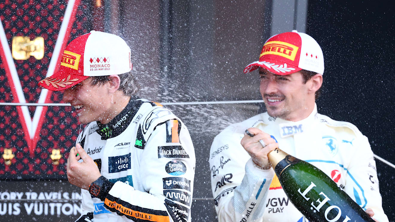 MONTE-CARLO, MONACO - MAY 25: Second placed Charles Leclerc of Monaco and Scuderia Ferrari sprays champagne in the face of Third placed Oscar Piastri of Australia and McLaren on the podium during the F1 Grand Prix of Monaco at Circuit de Monaco on May 25, 2025 in Monte-Carlo, Monaco. (Photo by Clive Rose/Getty Images)