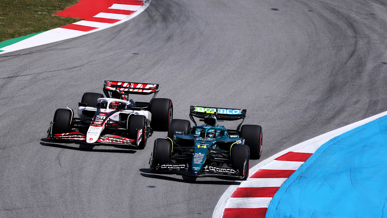 BARCELONA, SPAIN - JUNE 01: Fernando Alonso of Spain driving the (14) Aston Martin F1 Team AMR25 Mercedes and Esteban Ocon of France driving the (31) Haas F1 VF-25 Ferrari battle for track position on track during the F1 Grand Prix of Spain at Circuit de Barcelona-Catalunya on June 01, 2025 in Barcelona, Spain. (Photo by Clive Rose - Formula 1/Formula 1 via Getty Images)