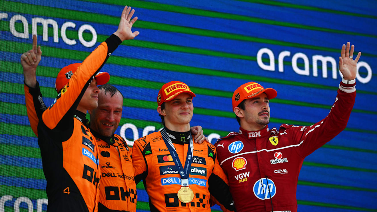 BARCELONA, SPAIN - JUNE 01: Race winner Oscar Piastri of Australia and McLaren Second placed Lando Norris of Great Britain and McLaren Third placed Charles Leclerc of Monaco and Scuderia Ferrari and the McLaren trophy delegate on the podium during the F1 Grand Prix of Spain at Circuit de Barcelona-Catalunya on June 01, 2025 in Barcelona, Spain. (Photo by Clive Rose - Formula 1/Formula 1 via Getty Images)