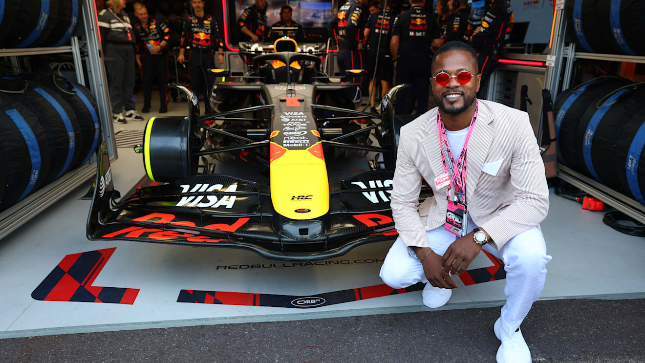 Former Manchester United footballer Patrice Evra outside the Red Bull garage