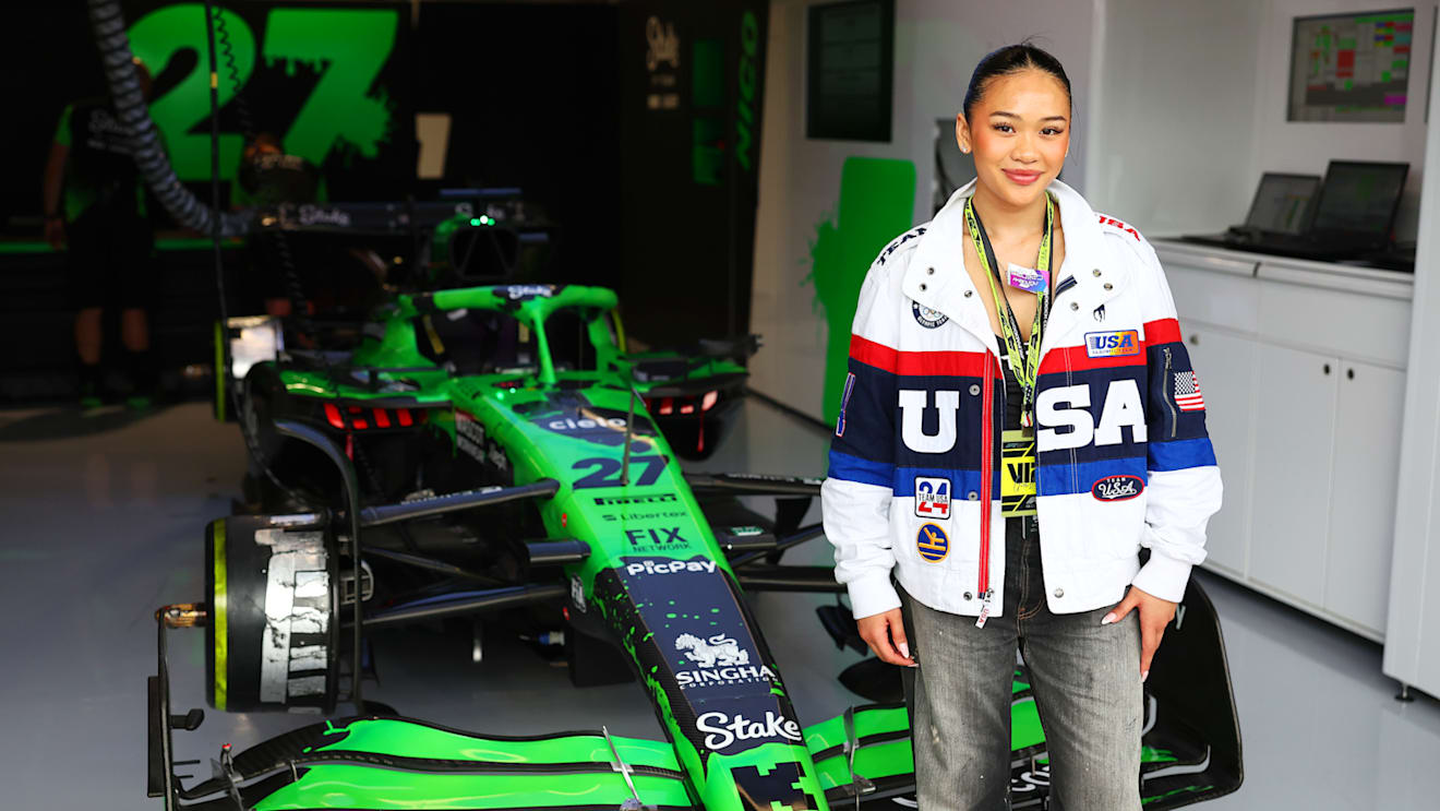 American artistic gymnast Suni Lee poses next to Nico Hulkenberg's Sauber
