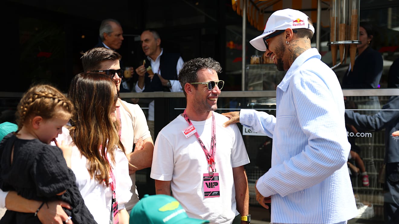 Cyclist Mark Cavendish chats with US fencer Miles Chamley-Watson in the Paddock during FP3 in Monaco
