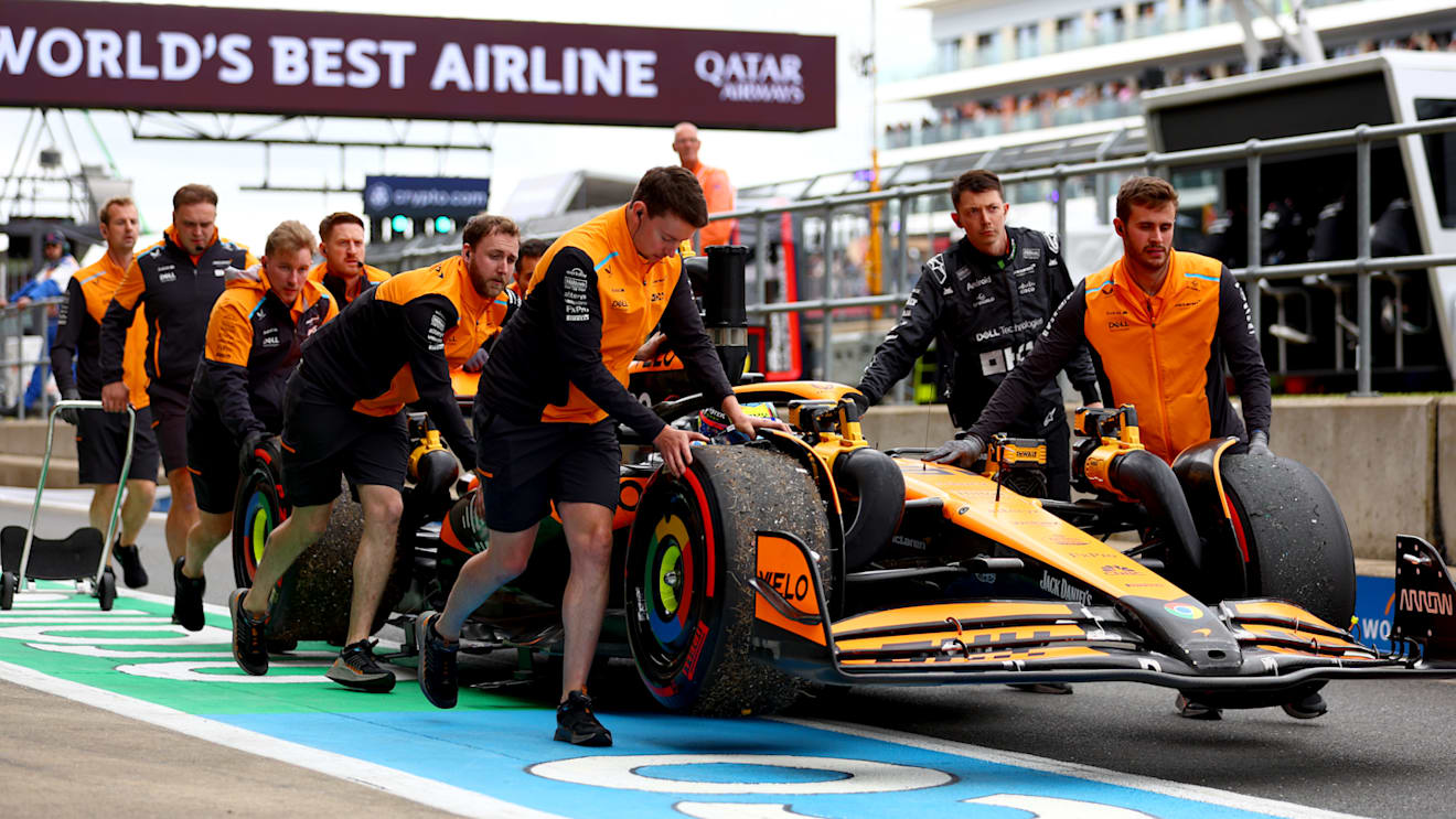 NORTHAMPTON, ENGLAND - JULY 05: The car of Oscar Piastri of Australia and McLaren is pushed in the Pitlane during practice ahead of the F1 Grand Prix of Great Britain at Silverstone Circuit on July 05, 2024 in Northampton, England. (Photo by Bryn Lennon - Formula 1/Formula 1 via Getty Images)