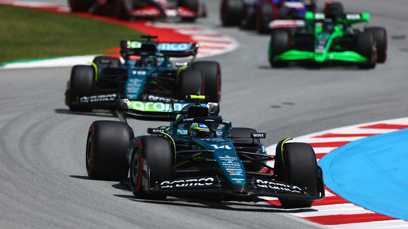 BARCELONA, SPAIN - JUNE 23: Fernando Alonso of Spain driving the (14) Aston Martin AMR24 Mercedes leads Lance Stroll of Canada driving the (18) Aston Martin AMR24 Mercedes during the F1 Grand Prix of Spain at Circuit de Barcelona-Catalunya on June 23, 2024 in Barcelona, Spain. (Photo by Clive Rose - Formula 1/Formula 1 via Getty Images)