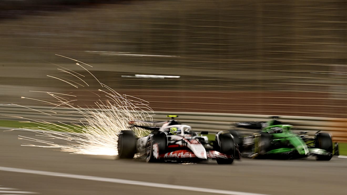 BAHRAIN, BAHRAIN - APRIL 13: Sparks fly behind from Oliver Bearman of Great Britain driving the (87) Haas F1 VF-25 Ferrari as he passes Nico Hulkenberg of Germany driving the (27) Kick Sauber C45 Ferrari on track during the F1 Grand Prix of Bahrain at Bahrain International Circuit on April 13, 2025 in Bahrain, Bahrain. (Photo by Mark Sutton - Formula 1/Formula 1 via Getty Images)