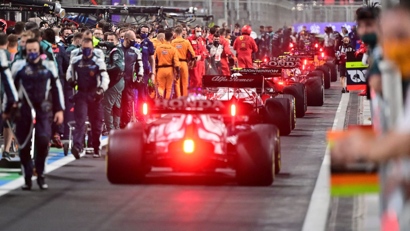 Drivers line up in the pit lane during a stop in the session  of the Formula One Saudi Arabian